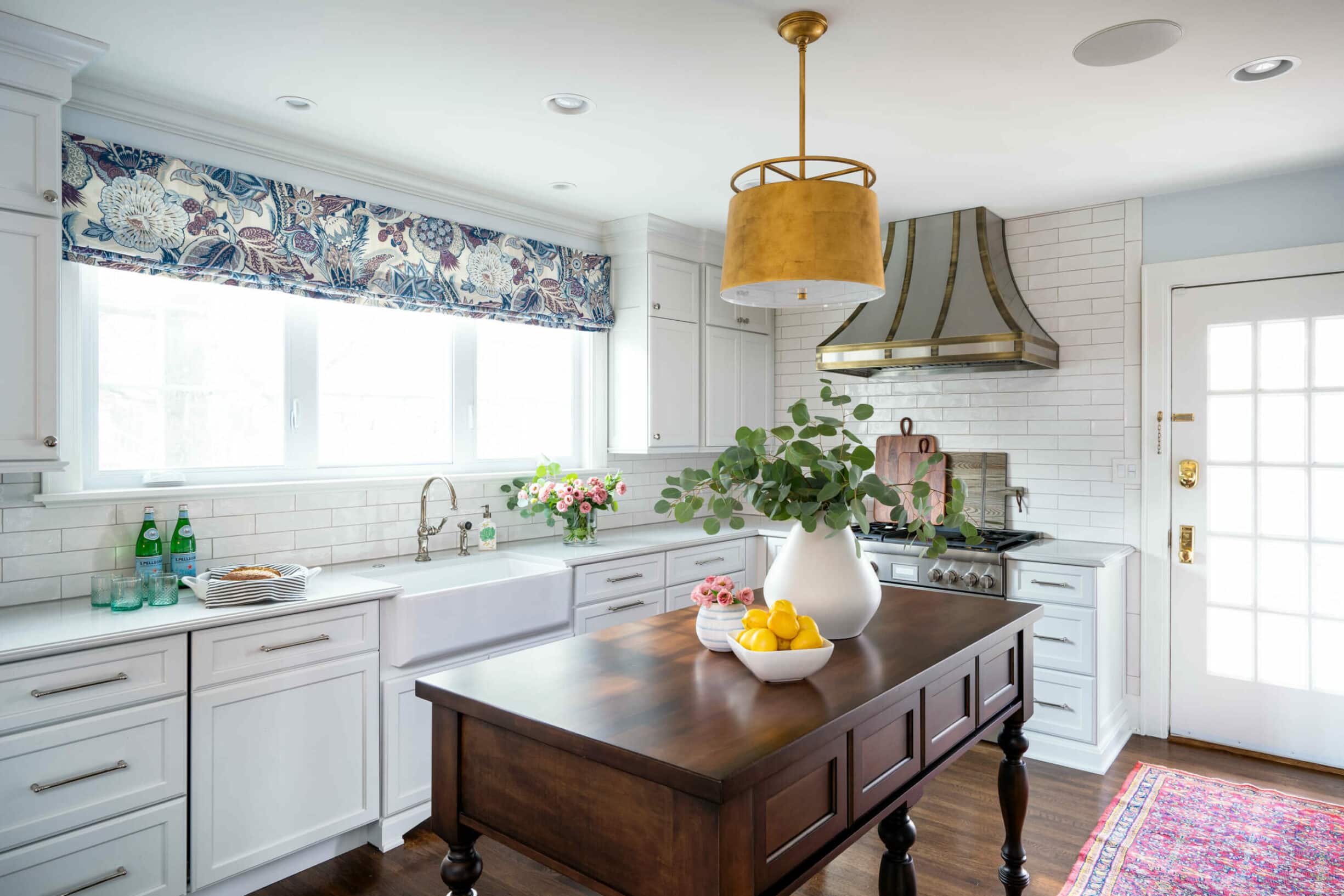 Reusch Interior Design - Hyde Park - Cincinnati, OH Kitchen Remodel. Top Cincinnati Interior Designer Laney Reusch has designed this kitchen to suit her client's style. Reusch Interior Design's timeless remodel of this 1920's Hyde Park home feels light and fresh. It features bespoke kitchen cabinetry, custom metal range hood design, and updated lighting. The space feels so much more open thanks to the help of Cincinnati's top interior designer, Laney Reusch - founder of Reusch Interior Design.