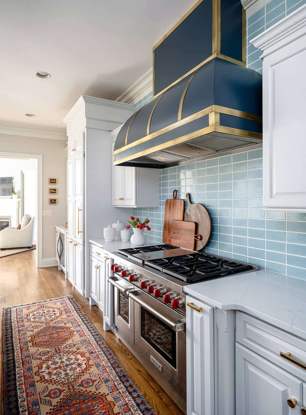 Laney Reusch Interior Design - Cincinnati Interior Designer - gourmet kitchen with navy and gold range hood
